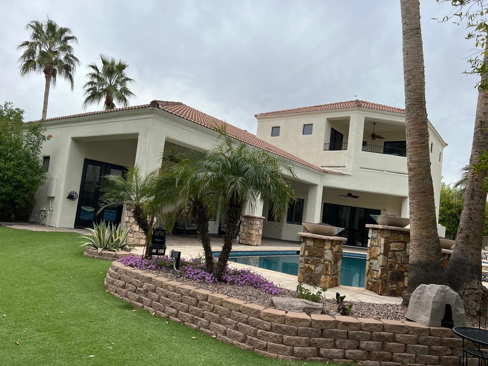 The same poolside home finished in clean cream stucco